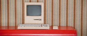 Un ordinateur rétro sur un bureau rouge