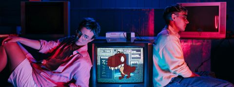 deux teenagers à côté d'une télé avec le Raptor