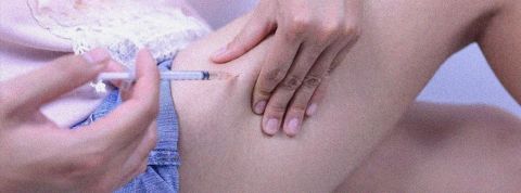 Une personne en train de se faire une piqure dans la cuisse