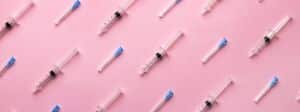 Des seringues sur fond rose