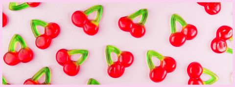 Des bonbons cerise sur fond rose