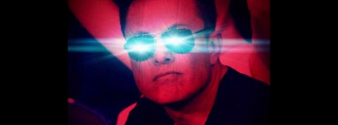 elon muske en filtre rouge avec les yeux bleu qui brillent.