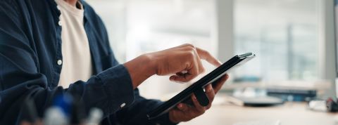 Businessman, hands and tablet in office for research, project planning and scroll on networking platform. Employee, tech and typing at desk for communication, email draft or browsing for productivity